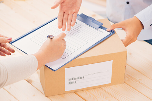 Lady signing for a package